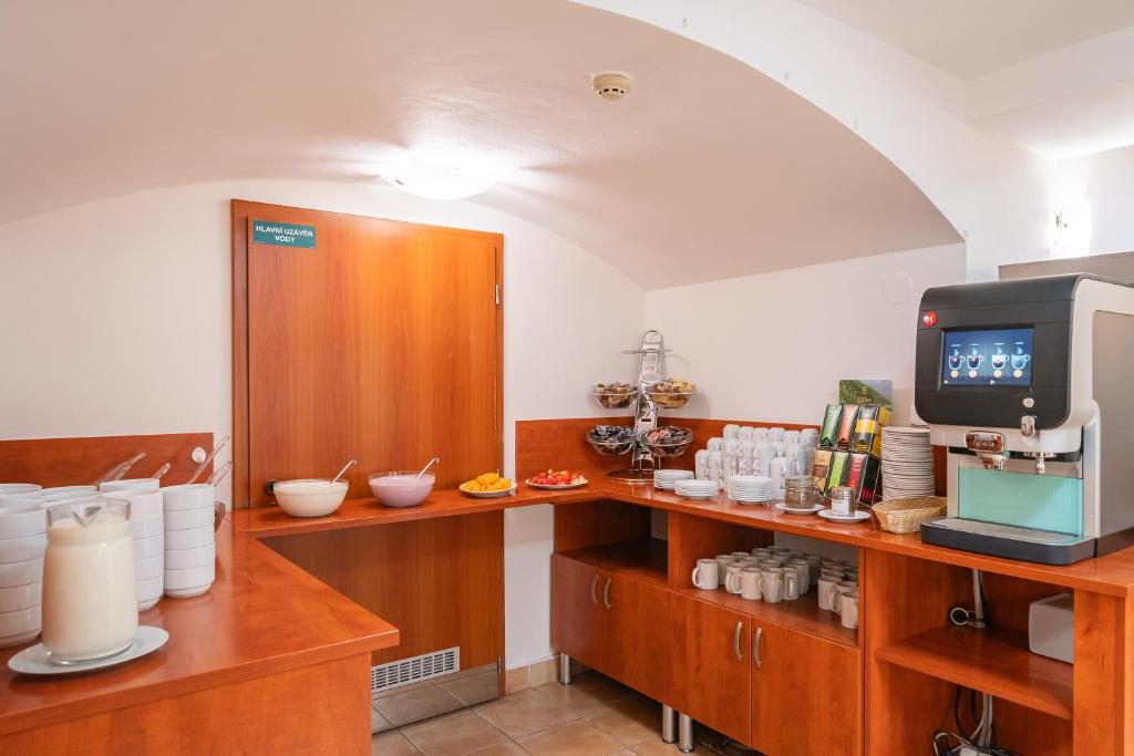 a kitchen with a counter with bowls and a tv at City Central De Luxe in Prague