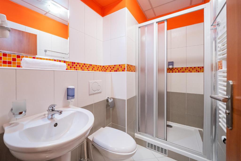 a bathroom with a sink and a toilet and a shower at City Central De Luxe in Prague