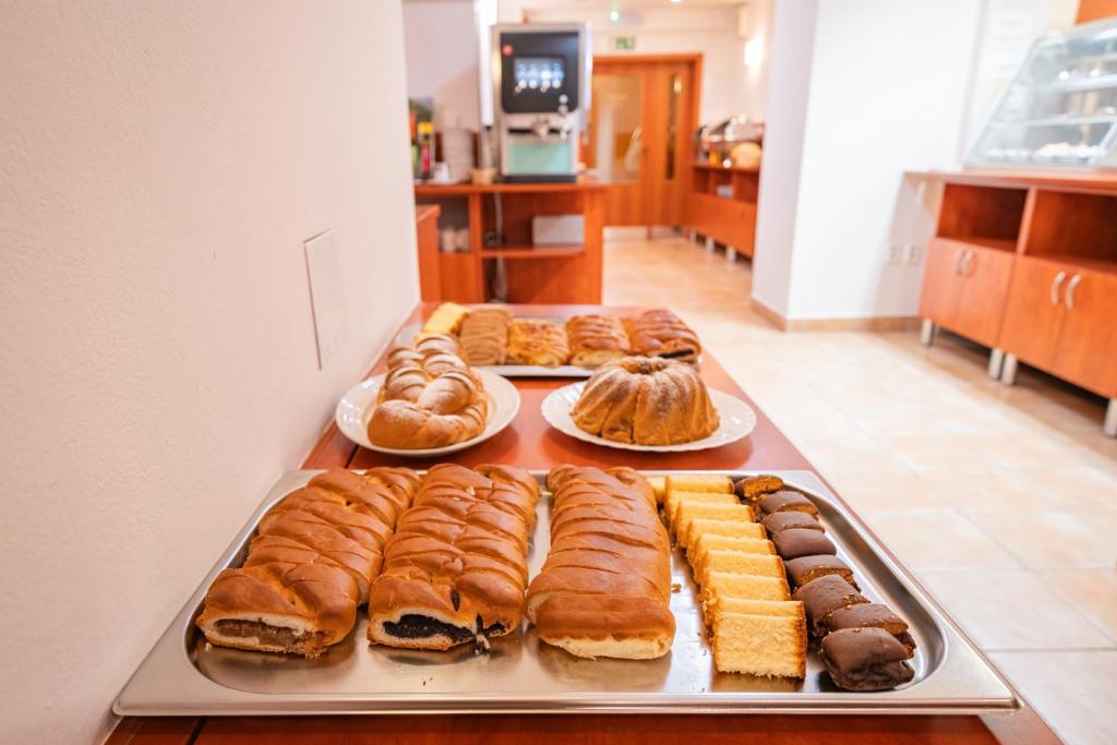 a bunch of pastries on a tray on a table at City Central De Luxe in Prague