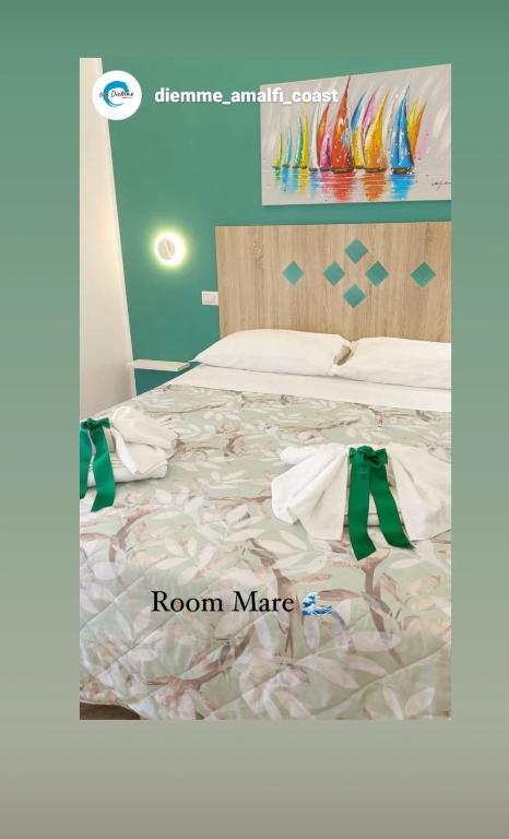 a bedroom with a bed with a room mate sign on it at B&B DieMme Amalfi Coast in Vietri sul Mare