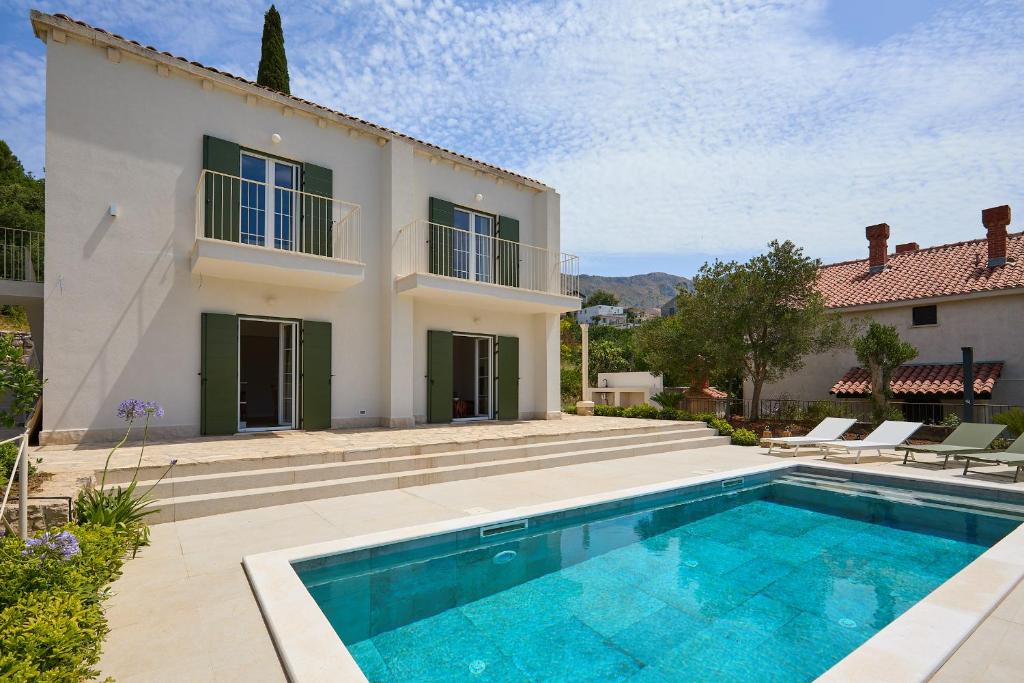 an exterior view of a villa with a swimming pool at Hedera Estate Villa Hedera XVIII in Mlini