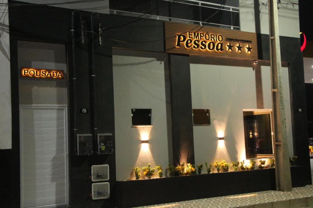 a store front with lights in the windows at night at Liziane Souza da Silva in Catarina