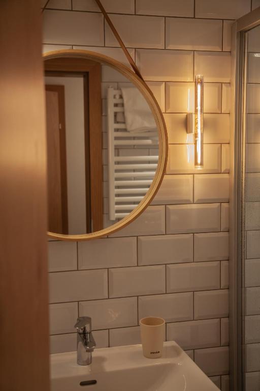 a bathroom with a sink and a mirror at VOM REITER, Ferienwohnung am Bauernhof mit Bergblick und privater Infrarotkabine, Inklusive Sommercard in Schladming