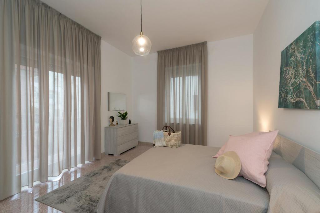 a bedroom with a large bed with pink pillows at Casa Giulia in Castellammare di Stabia