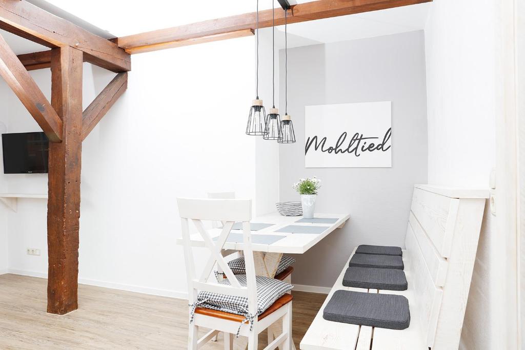 a room with a white desk and a table at Landleev - Bauernhof "Hofbude Fehmarn" in Fehmarn