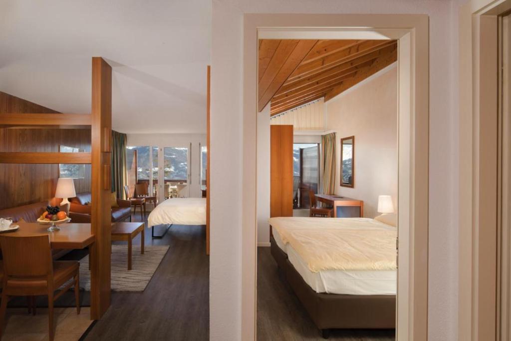 Postel nebo postele na pokoji v ubytování Hotel Helvetia Intergolf