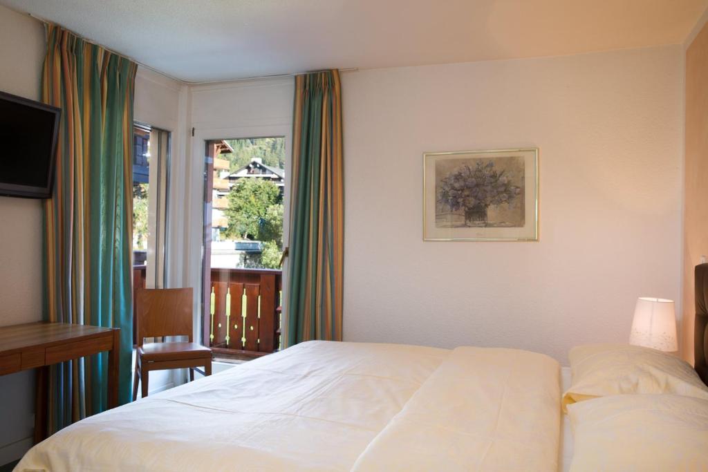 Postel nebo postele na pokoji v ubytování Hotel Helvetia Intergolf