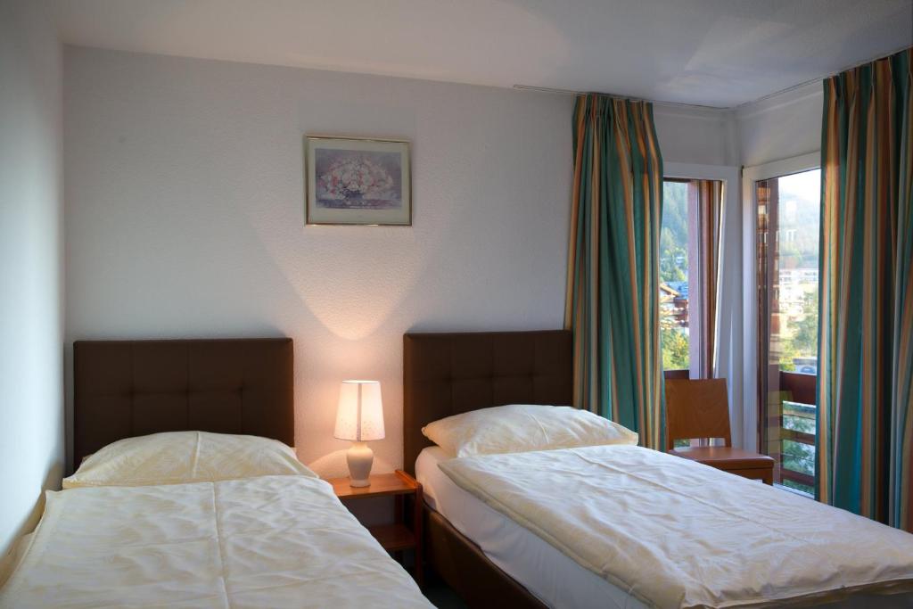 Postel nebo postele na pokoji v ubytování Hotel Helvetia Intergolf
