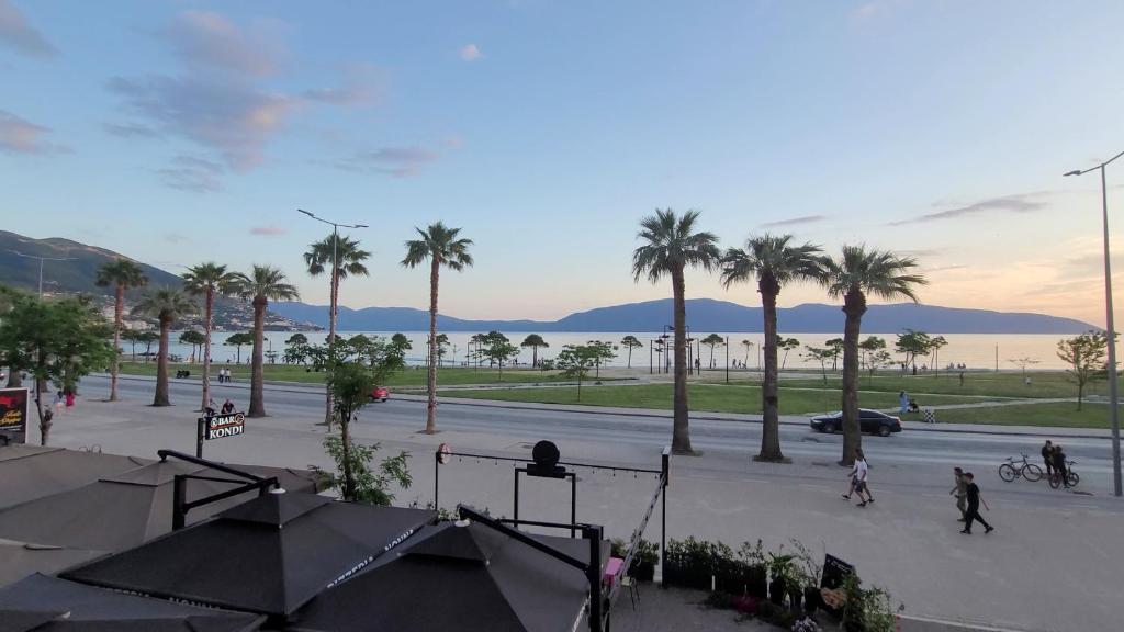 a view of a street with palm trees and a road at Haris Hotel & Suites in Vlorë