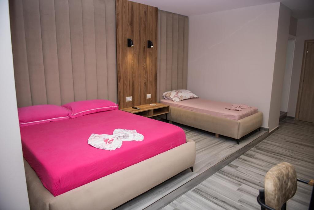 Postel nebo postele na pokoji v ubytování New Donantelo Hotel