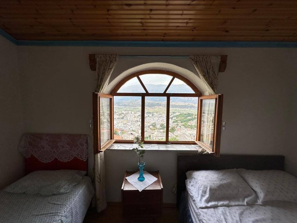 a room with two beds and a window at Villa Zeko in Gjirokastër