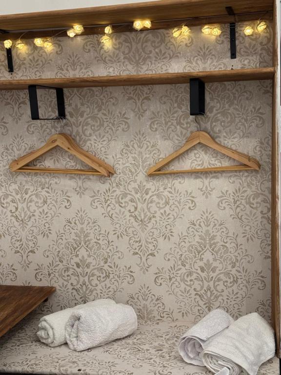 a bathroom with towels and lights on a wall at El Mirador de Benialfaqui, Apartamento Els Cireres in Benialfaquí