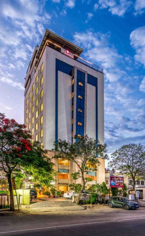 a tall white building with a sign on it at Libra Lords Inn, Jaipur in Jaipur