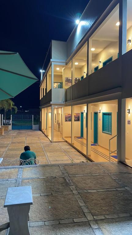 a building with a bench in front of it at night at Voar Pousada in Barreirinhas