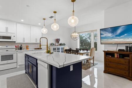 a kitchen with a counter and a tv in it at Fishermans Landing on The Bay- Las Marinas in South Padre Island