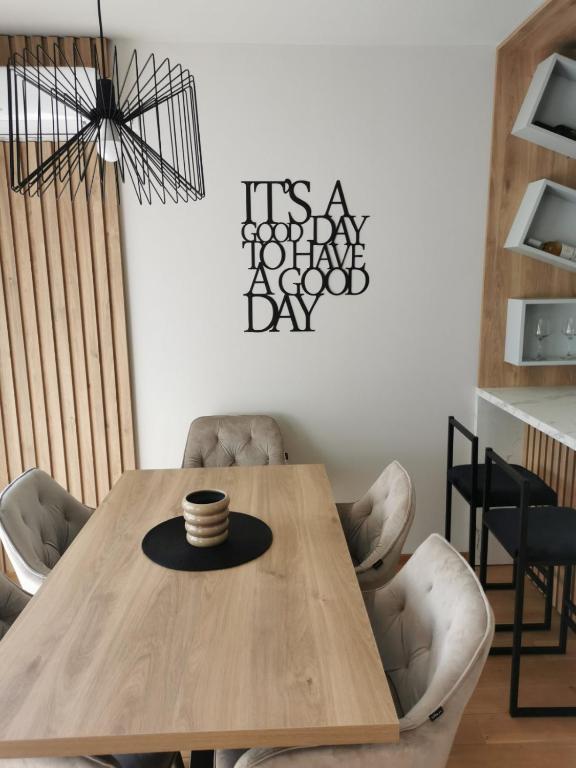 a dining room with a wooden table and chairs at Centar Park Lux in Vrnjačka Banja