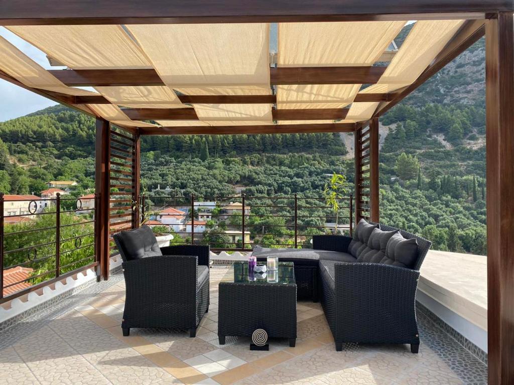 a patio with a couch and chairs and a table at Stefanos house in Parga