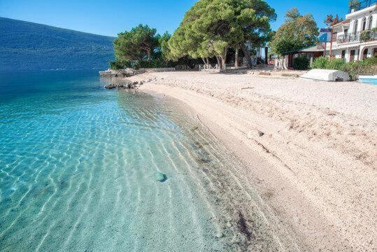 an aerial view of a beach next to the water at комната с отдельным входом in Baošići