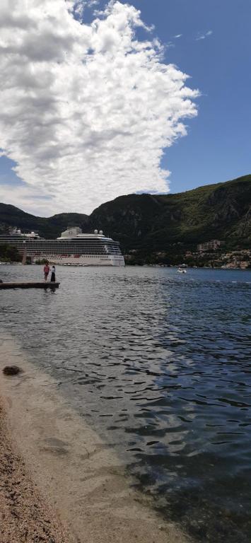 two people sitting on a boat in the water at APARTMAN Biser in Kotor