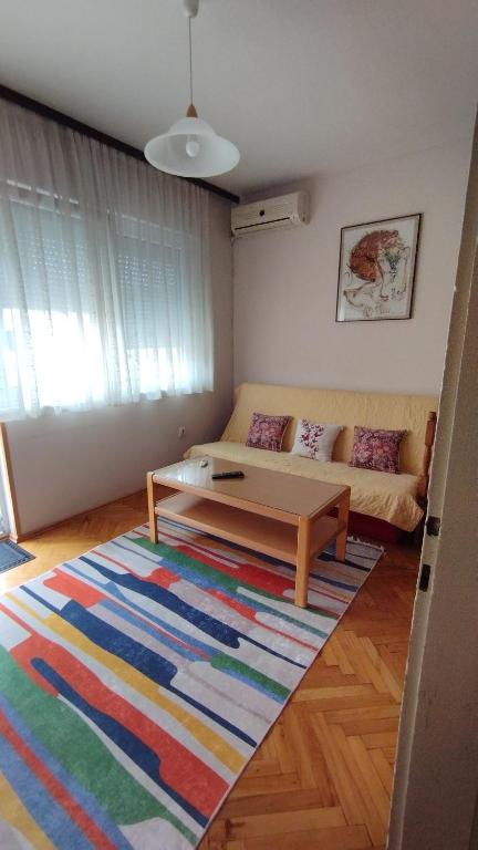 a living room with a couch and a coffee table at NANA apartment in Ohrid