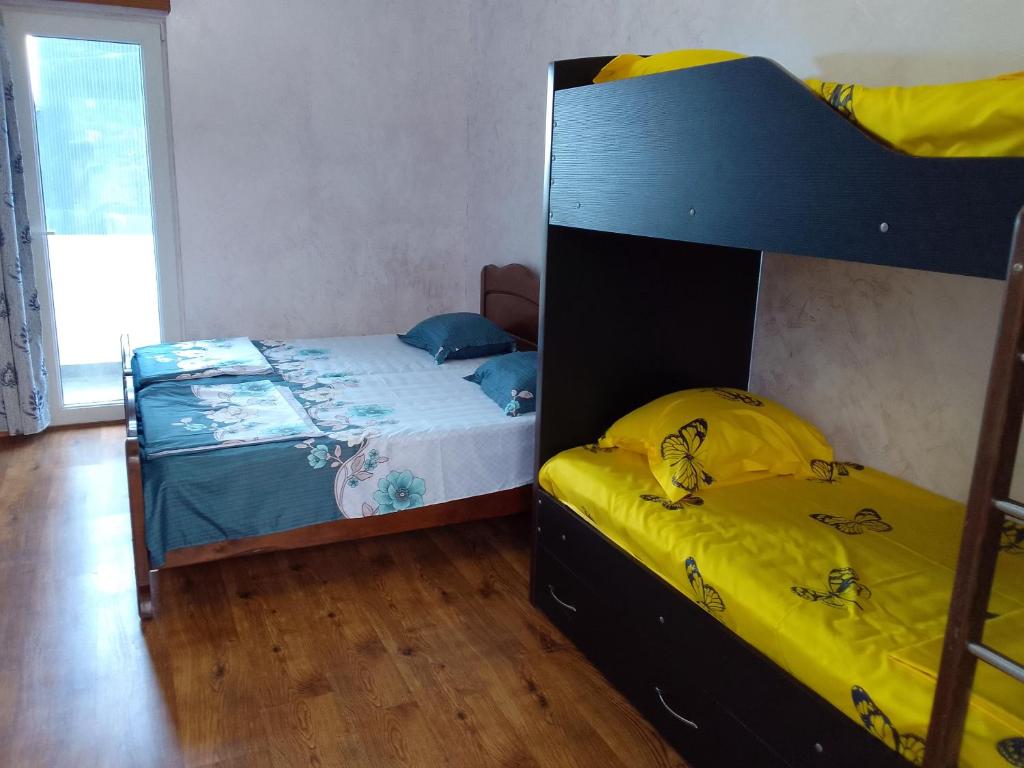 a bedroom with two bunk beds and a wooden floor at Nugo house in Batumi