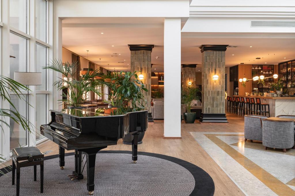 a piano in the lobby of a hotel at Onyria Quinta da Marinha Hotel in Cascais