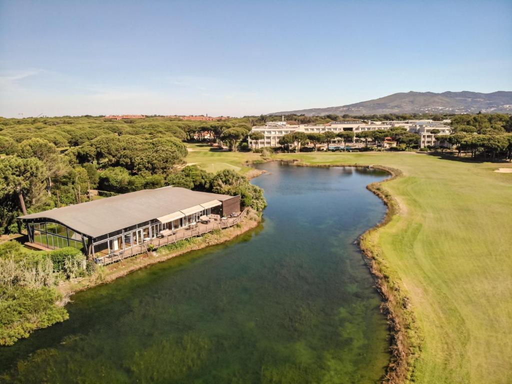 an aerial view of a golf course and a river at Onyria Quinta da Marinha Hotel in Cascais
