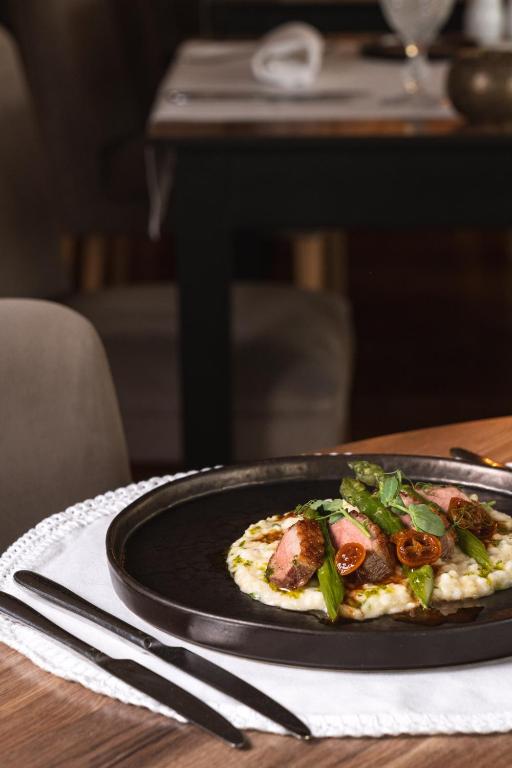a plate of food on a table with a plate of food at Onyria Quinta da Marinha Hotel in Cascais