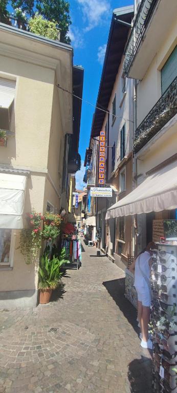 a woman walking down a street next to a building at la Strecia in Stresa
