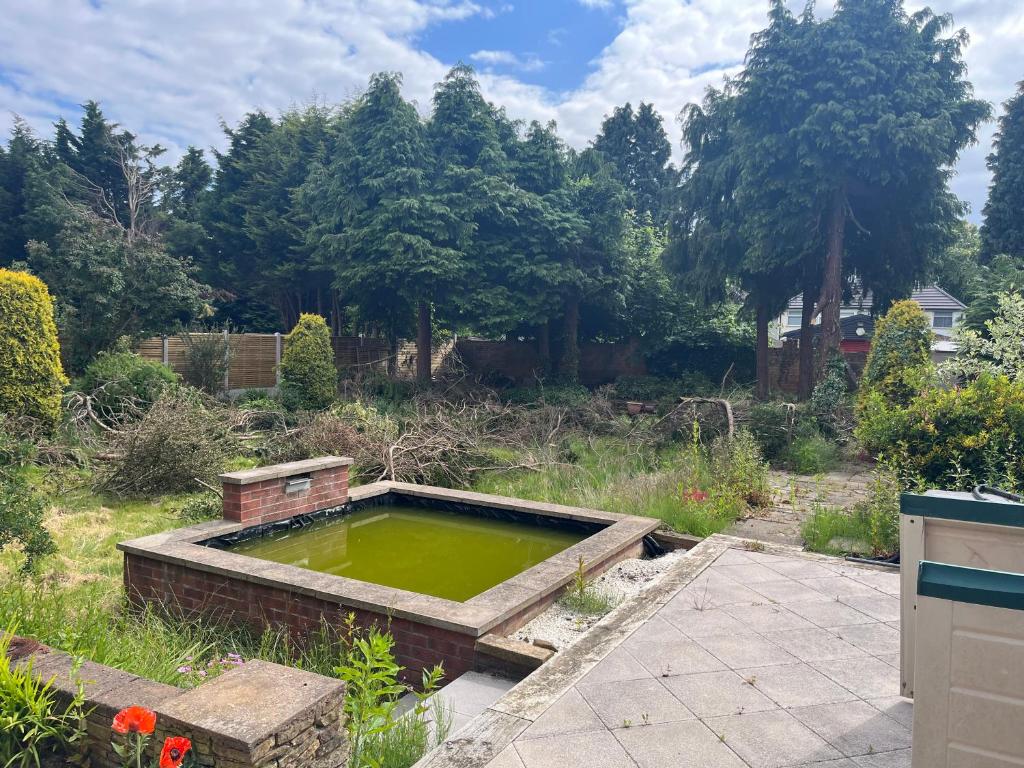 a pond in the middle of a garden at Guest Double Room in Birmingham