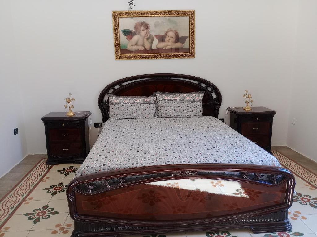 a bedroom with a large bed with two night stands at casa vacanze marinela in Casarano