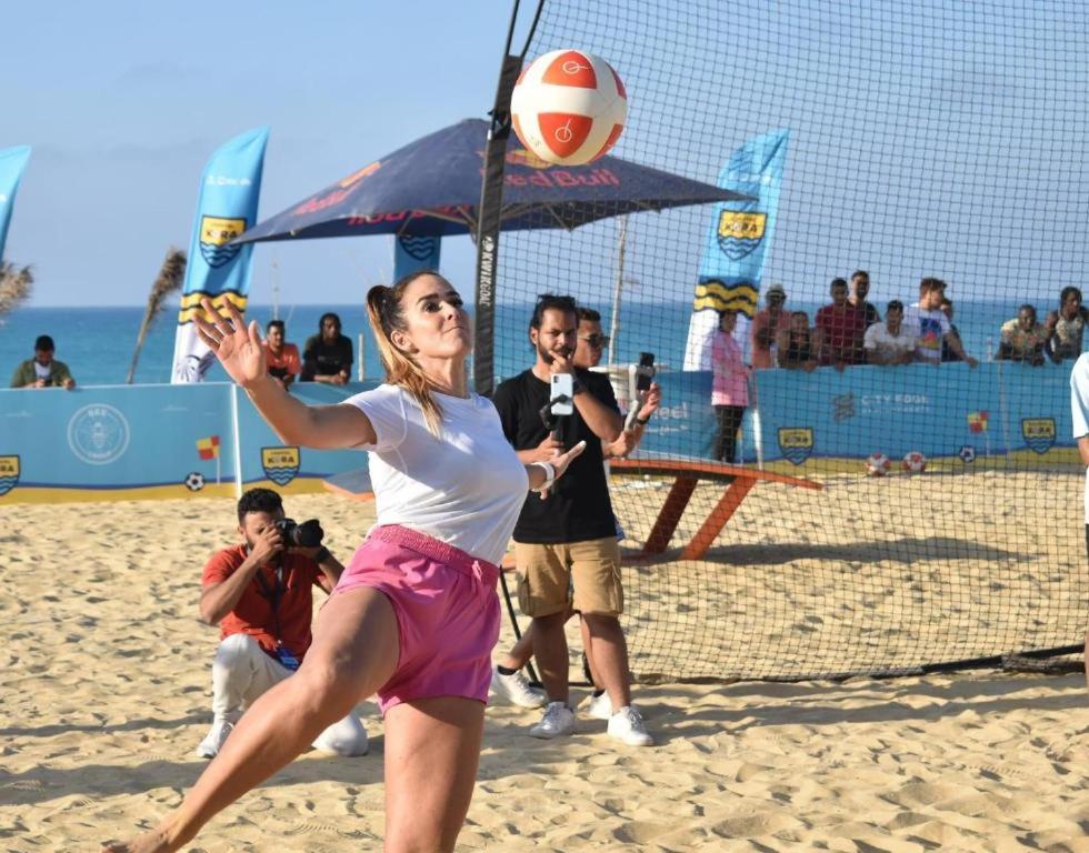 a woman hitting a volley ball on the beach at Down Town New ELalamein خلف الابراج وبجوار فندق ريكسوس العلمين in El Alamein