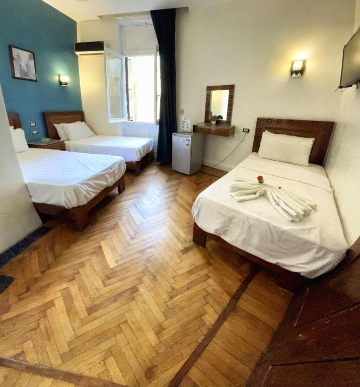 A bed or beds in a room at Minerva Grand Boutique
