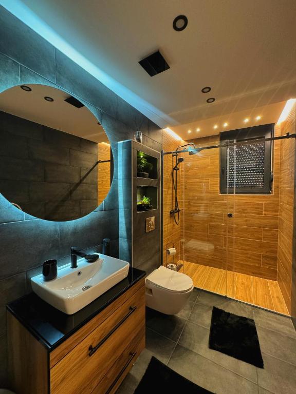 a bathroom with a sink and a toilet and a shower at HelVik Apartman Aqua Park in Vrnjačka Banja