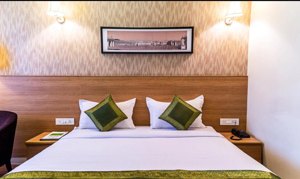 a hotel room with a bed and a picture on the wall at Olive Home Stay in Agra
