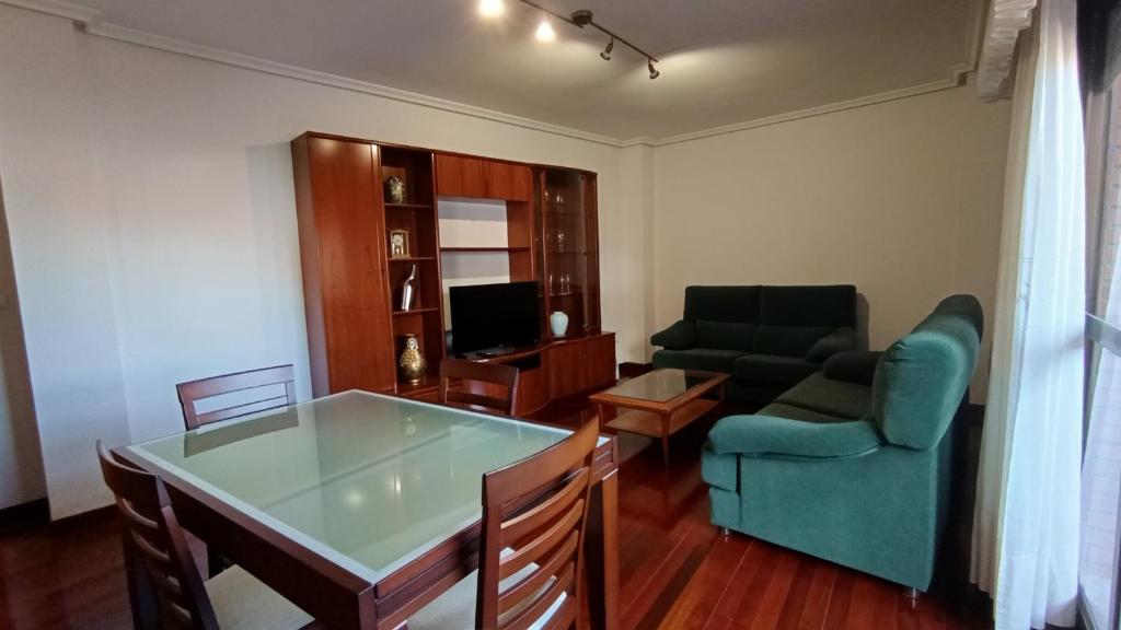 a living room with a couch and a table at O Xardín Termal in Ourense