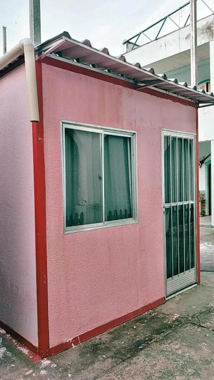a red building with a window on the side of it at Albergue Cultural Hostel in Rio de Janeiro