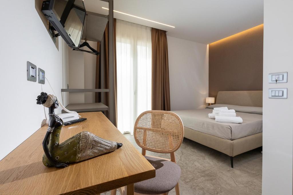 A bed or beds in a room at Hotel Vento del Sud