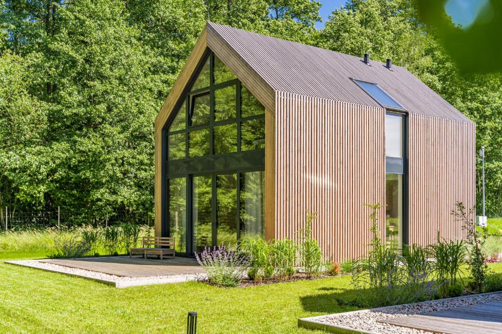 a small greenhouse in a garden with trees at Sasino Park 22 in Sasino