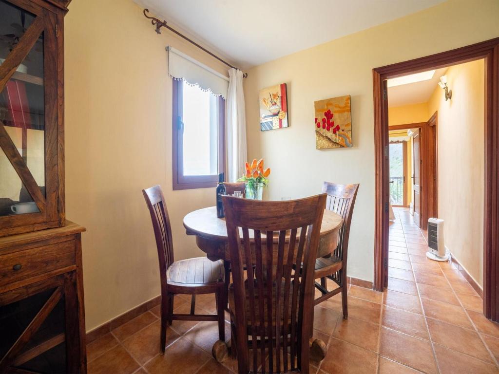 a dining room with a table and chairs at Holiday villa with pool in Teno Alto