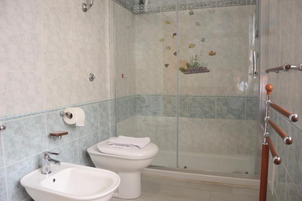 a bathroom with a shower and a toilet and a sink at Spiaggia LazzarettoHouse in Alghero