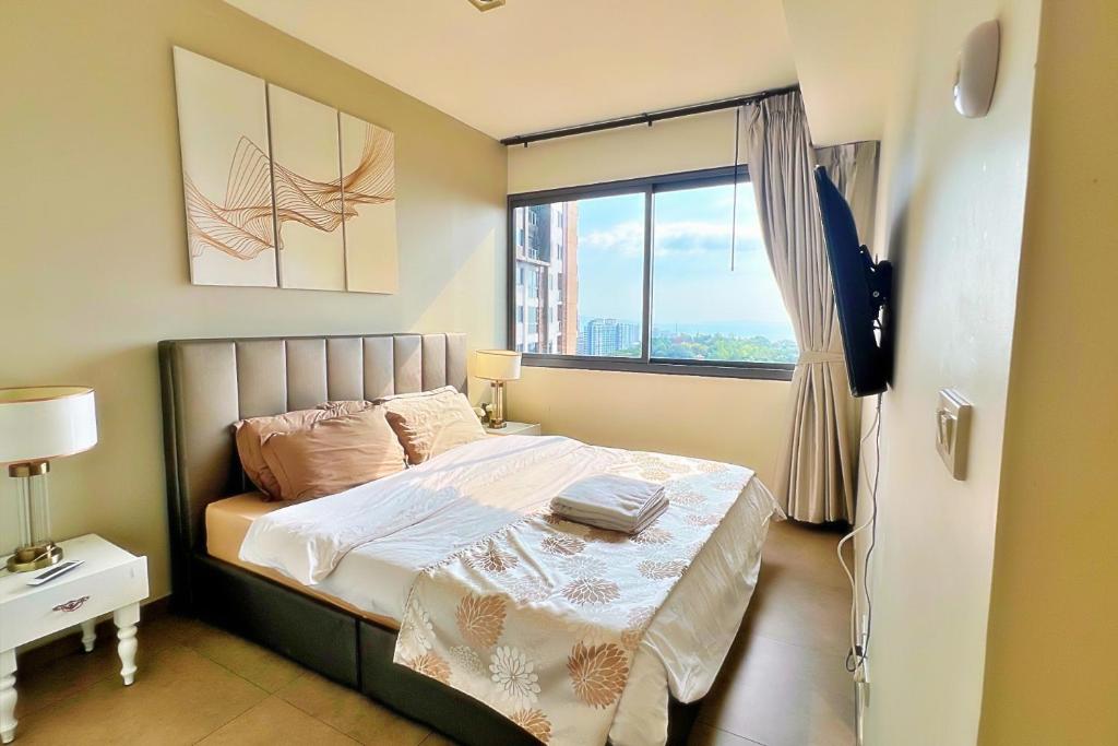 a small bedroom with a bed and a window at Walking Street Netflix 濒海雅居 两卧室奢华海景公寓 in Pattaya South