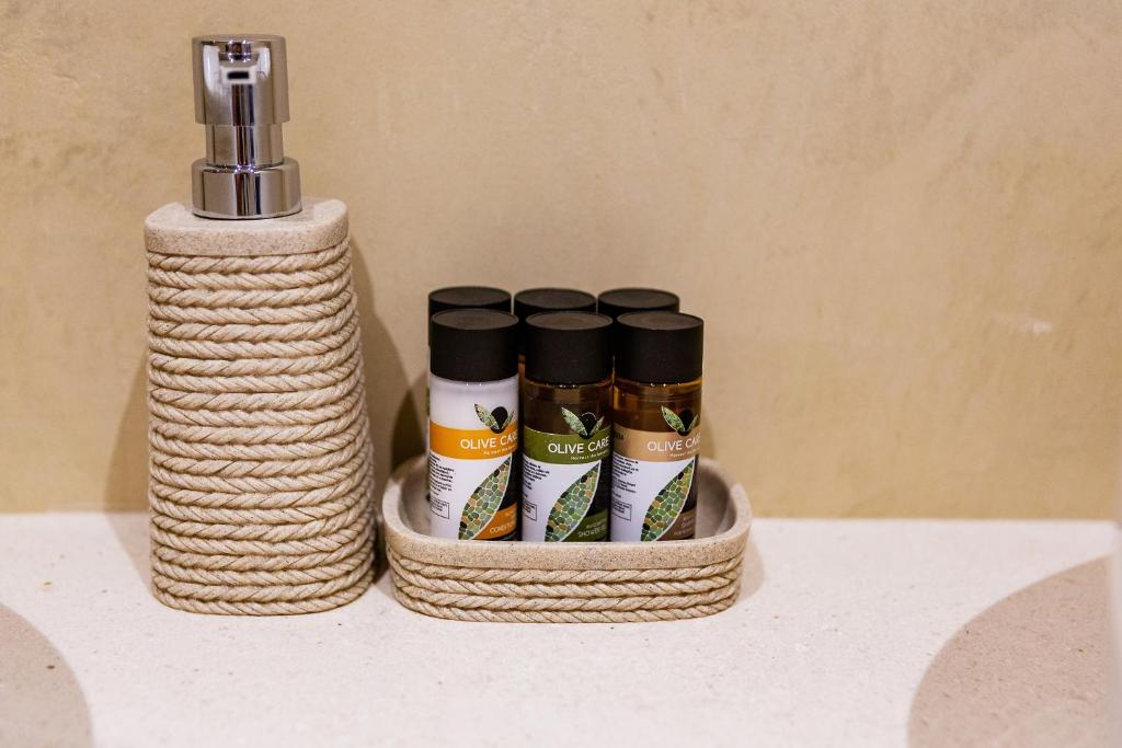 a group of five spices in a basket on a counter at Boutique hotel Ruzmarin SPA & Garden by Aycon in Budva