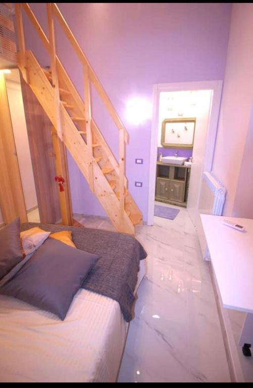a small room with a bed and a staircase at Oceania in Genoa