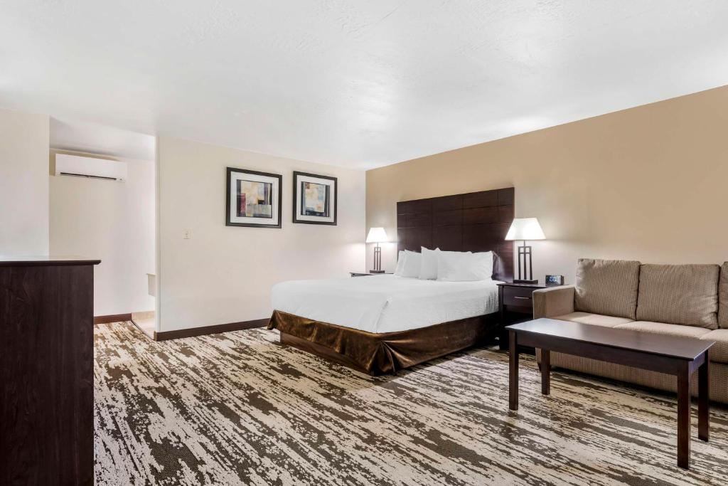 a hotel room with a bed and a couch at Best Western Prescottonian in Prescott