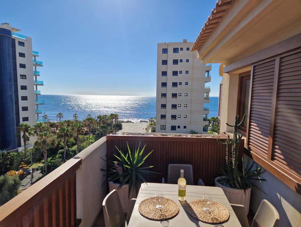 a balcony with a table and chairs and the ocean at PUNTA PRIMA Seaview in Torrevieja