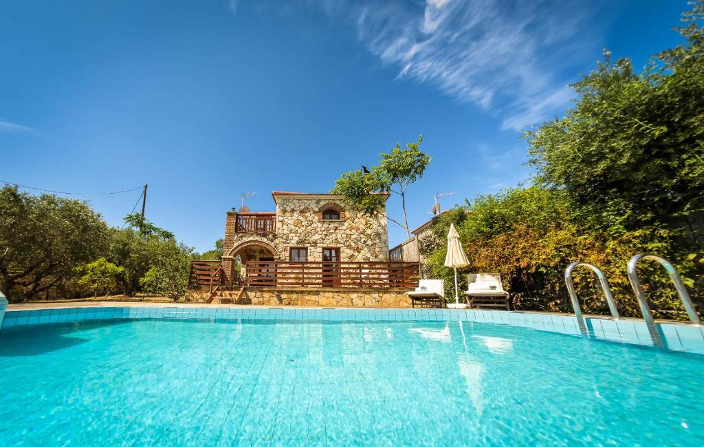 a large swimming pool in front of a house at Parys Villas in Tsilivi