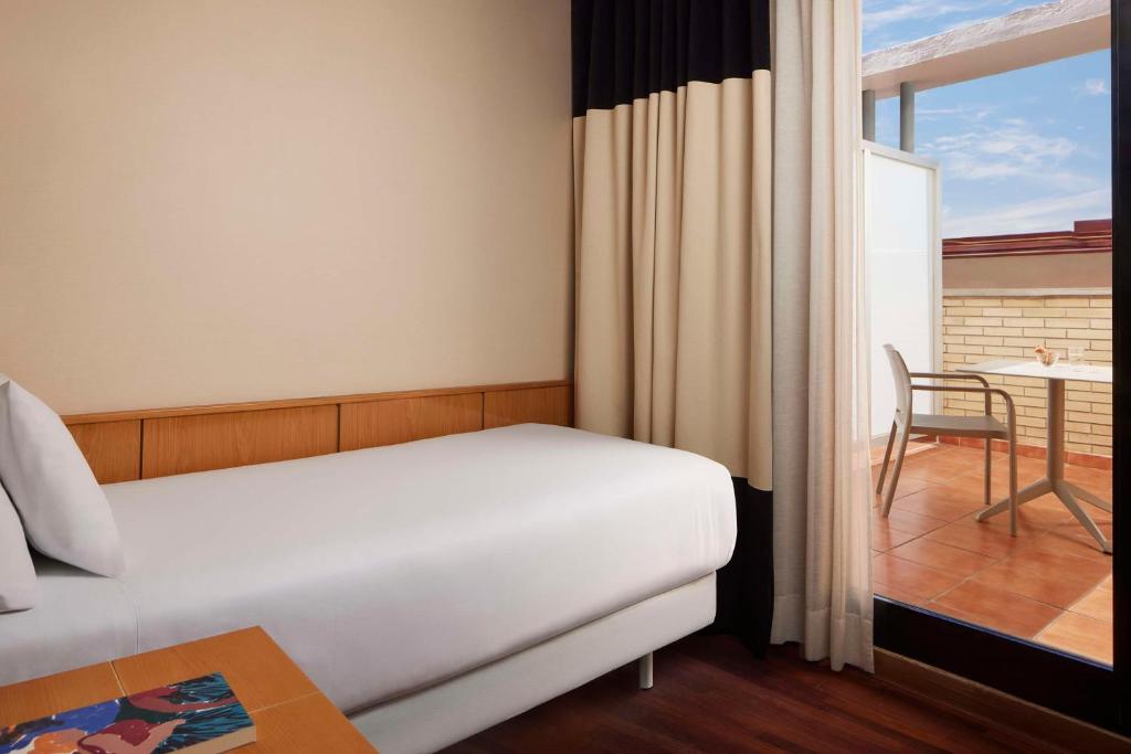 Cama o camas de una habitación en NH Ciudad de Valencia