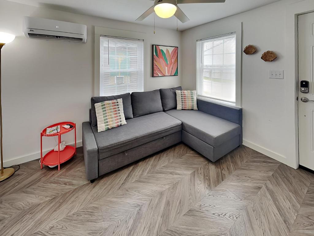 a living room with a gray couch in a room at Coral Cottage in Rockport
