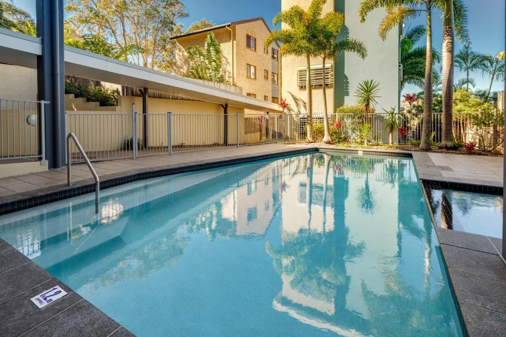 a swimming pool in the middle of a building at Ocean Breeze Retreat: Kings Coastal Apartment in Caloundra